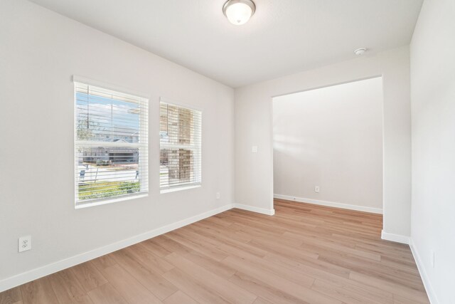 unfurnished room with light wood-type flooring