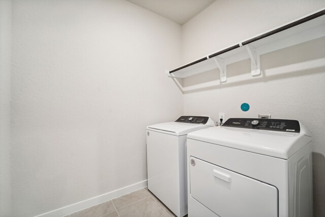 laundry area with light tile patterned floors and separate washer and dryer