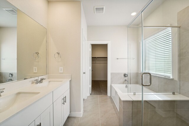 bathroom with tile patterned floors, vanity, and independent shower and bath