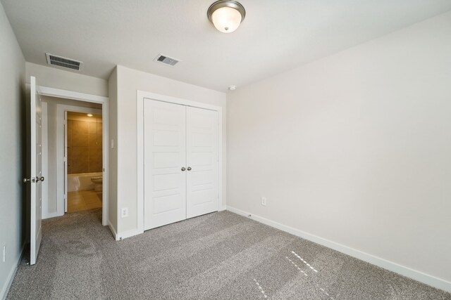 unfurnished bedroom featuring a closet and carpet