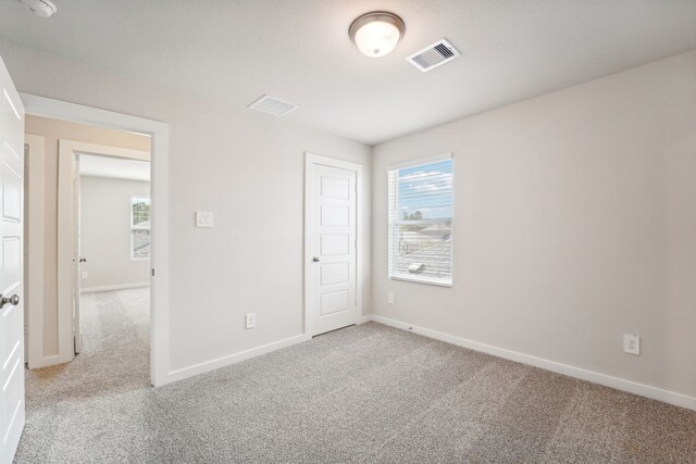 empty room featuring light colored carpet