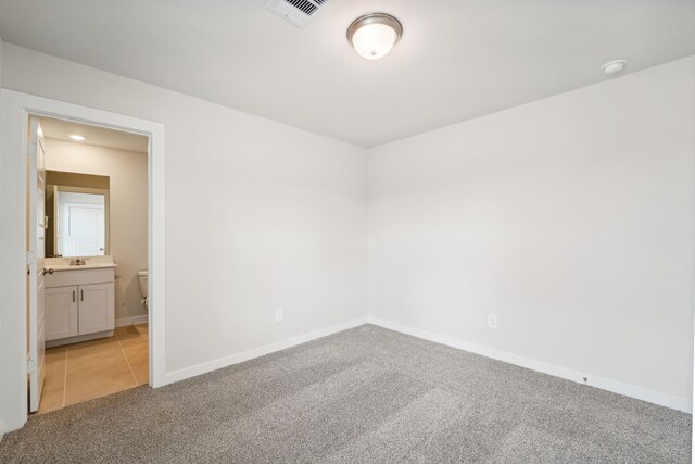 carpeted empty room with sink