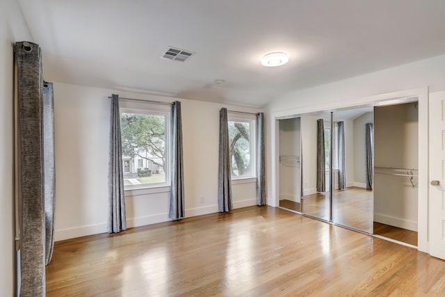 unfurnished bedroom with a closet and light hardwood / wood-style flooring