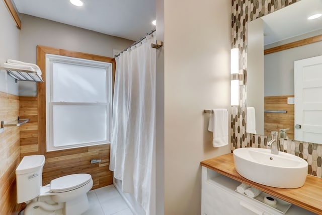 bathroom featuring tile patterned flooring, vanity, a shower with shower curtain, and toilet