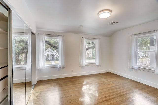 empty room featuring plenty of natural light and light hardwood / wood-style flooring