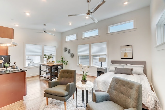 bedroom with multiple windows and light hardwood / wood-style floors