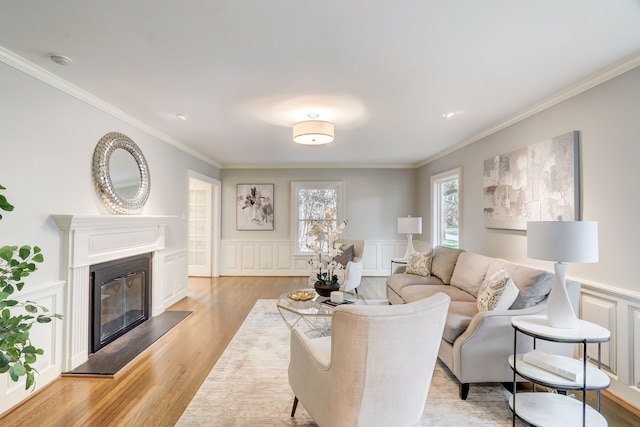 living room featuring ornamental molding and light hardwood / wood-style flooring