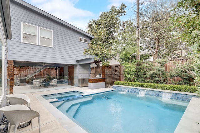 view of pool featuring pool water feature and a patio area