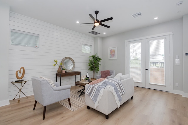 living room featuring french doors, light hardwood / wood-style floors, and ceiling fan