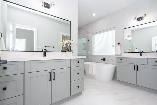 bathroom featuring vanity, tile walls, and independent shower and bath