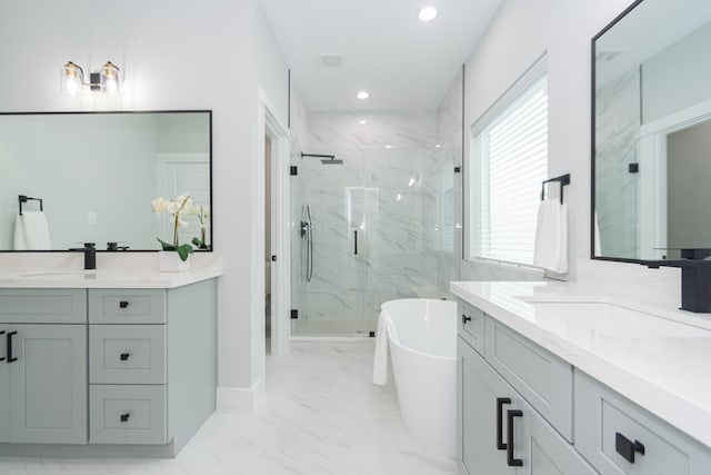 bathroom with vanity and independent shower and bath