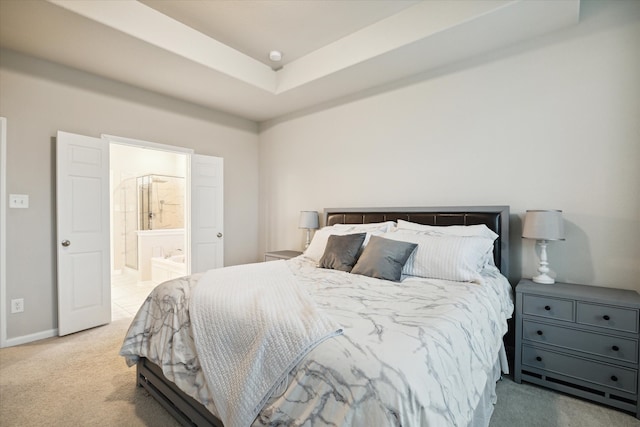 bedroom featuring ensuite bathroom and light colored carpet