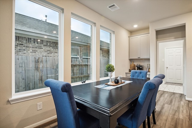 dining space featuring wood-type flooring