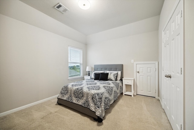 bedroom with a closet and light colored carpet