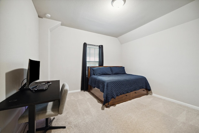 carpeted bedroom with vaulted ceiling