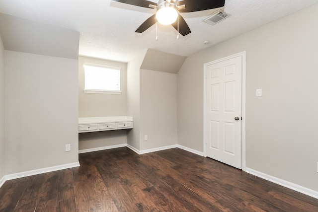 bonus room with dark wood-type flooring, ceiling fan, a textured ceiling, and vaulted ceiling