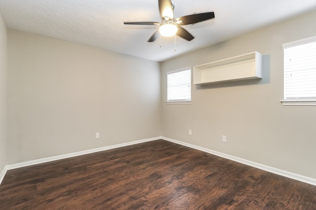 unfurnished room with ceiling fan, a textured ceiling, and dark hardwood / wood-style flooring