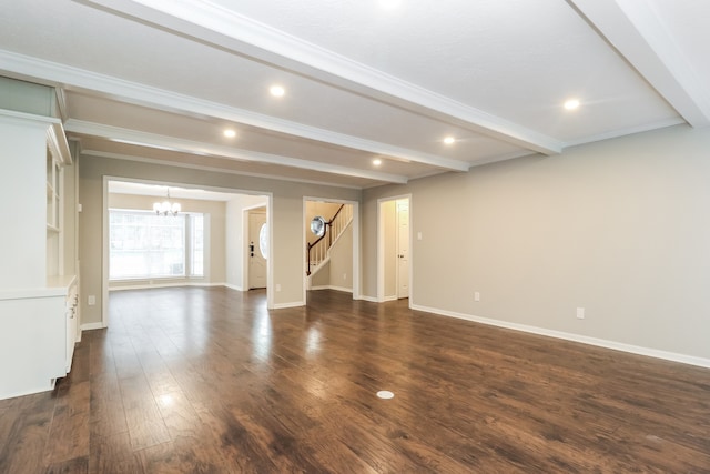 interior space featuring dark wood-type flooring, a chandelier, ornamental molding, and beam ceiling