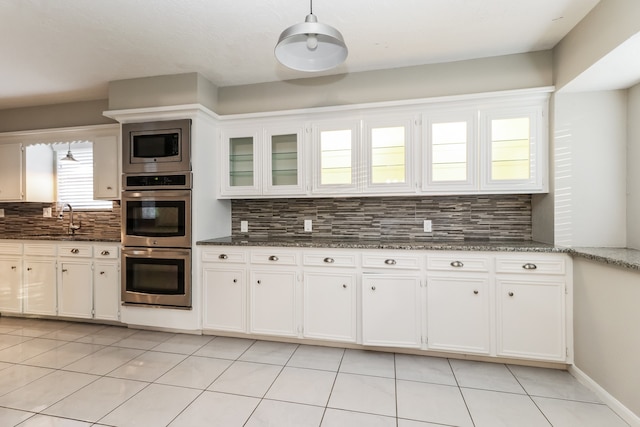 kitchen with white cabinetry, a wealth of natural light, appliances with stainless steel finishes, and backsplash