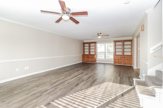 unfurnished living room with hardwood / wood-style floors, ceiling fan, and crown molding