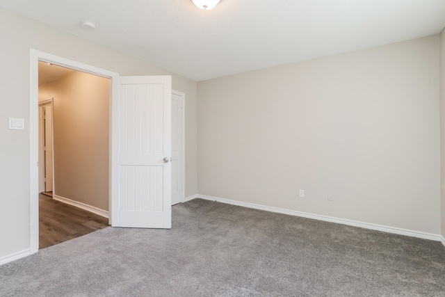 unfurnished bedroom featuring dark colored carpet