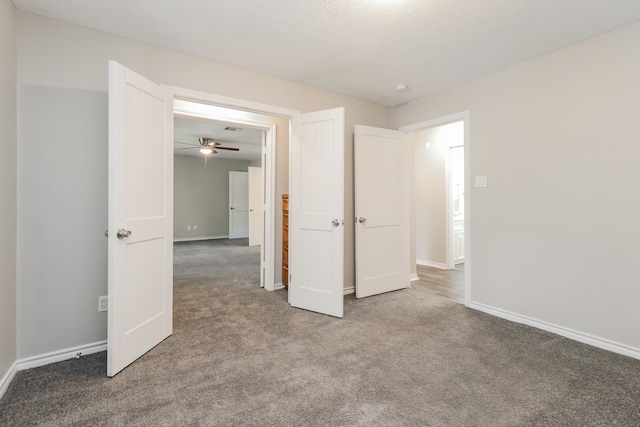 unfurnished bedroom featuring carpet flooring and a textured ceiling