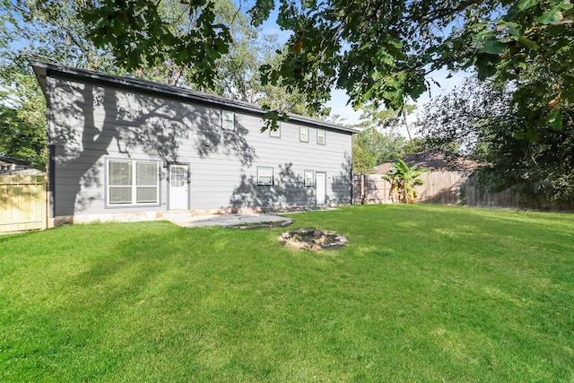 back of property featuring a yard and a patio area