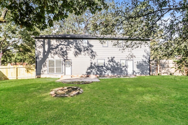 back of property with a patio and a yard