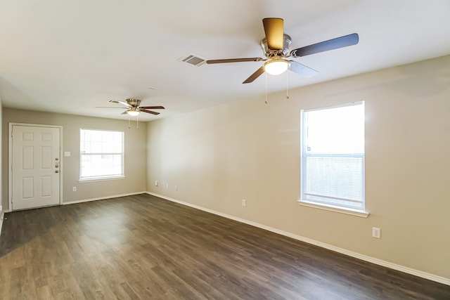 unfurnished room featuring ceiling fan and dark hardwood / wood-style floors