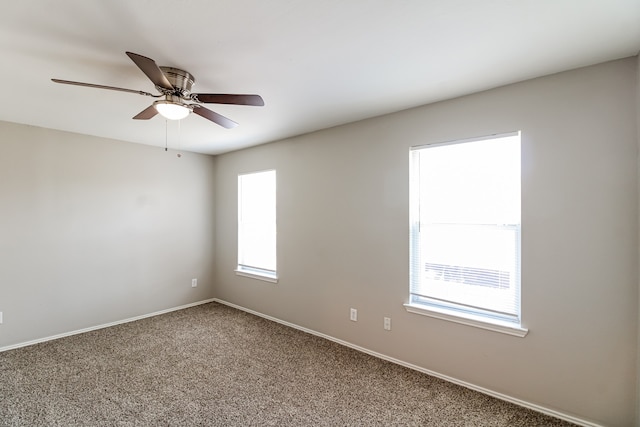 carpeted empty room featuring ceiling fan