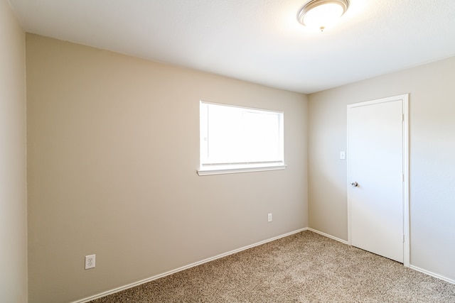 empty room featuring light carpet