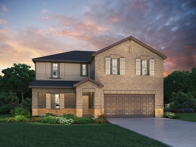 view of front of property featuring a yard and a garage