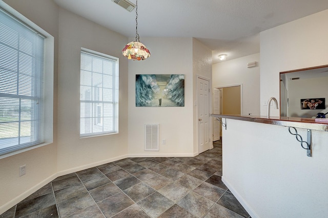3215 County Road 160, Alvin, TX 77511 - unfurnished dining area featuring baseboards, stone finish floors, and a sink