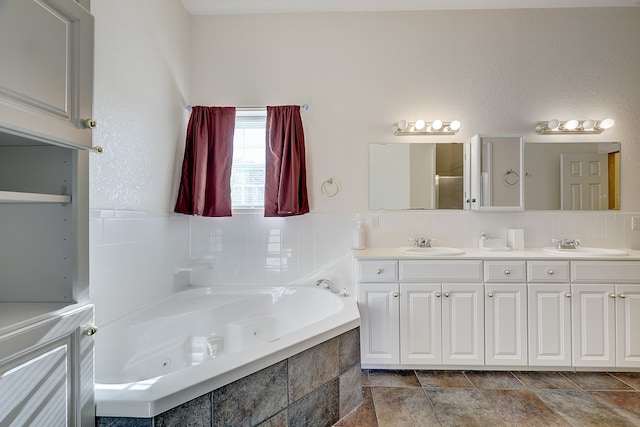 bathroom featuring vanity and tiled tub