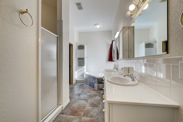 bathroom with independent shower and bath, vanity, and decorative backsplash