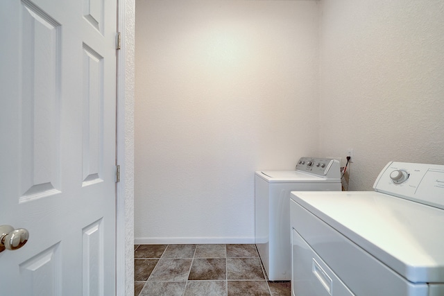 clothes washing area featuring separate washer and dryer