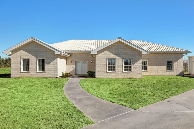 3215 County Road 160, Alvin, TX 77511 - ranch-style home with brick siding, a front lawn, and metal roof