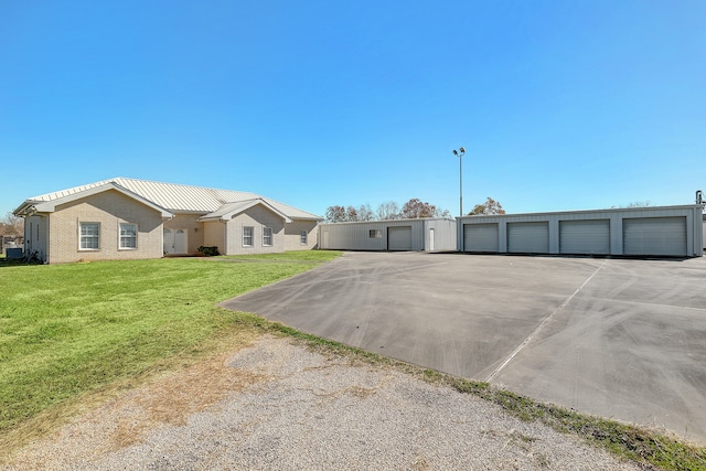 view of front of property featuring an outbuilding, a garage, and a front lawn