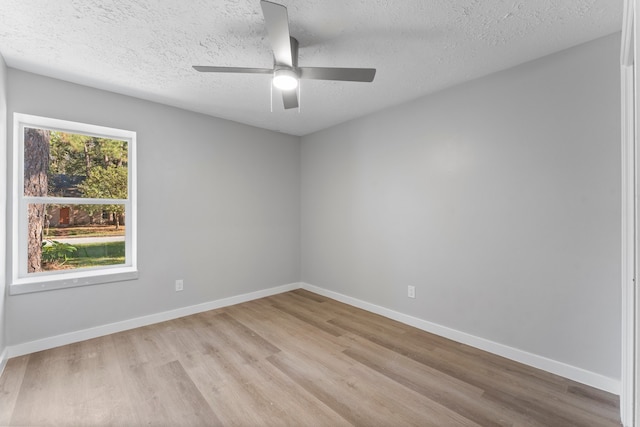 spare room with ceiling fan, light hardwood / wood-style floors, and a textured ceiling