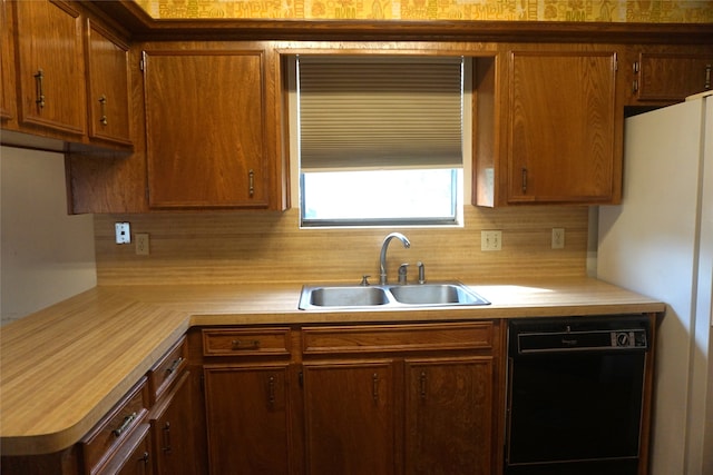 kitchen with tasteful backsplash, dishwasher, white refrigerator, and sink