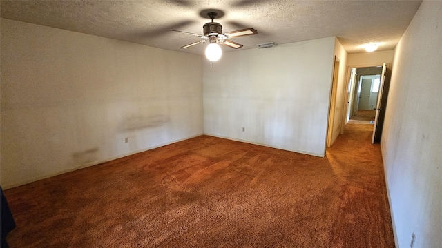 unfurnished room featuring a textured ceiling, carpet floors, and ceiling fan