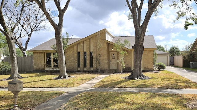 view of front of property featuring a front yard and a garage