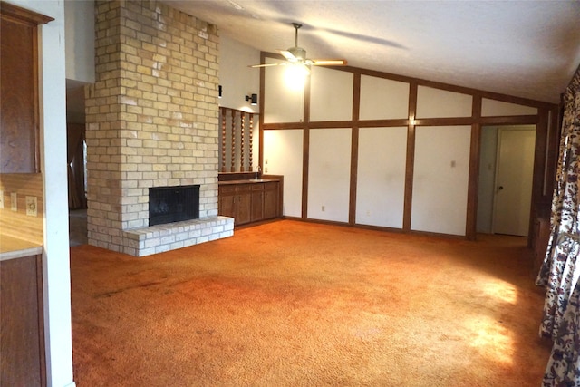 unfurnished living room with light carpet, a fireplace, high vaulted ceiling, and ceiling fan