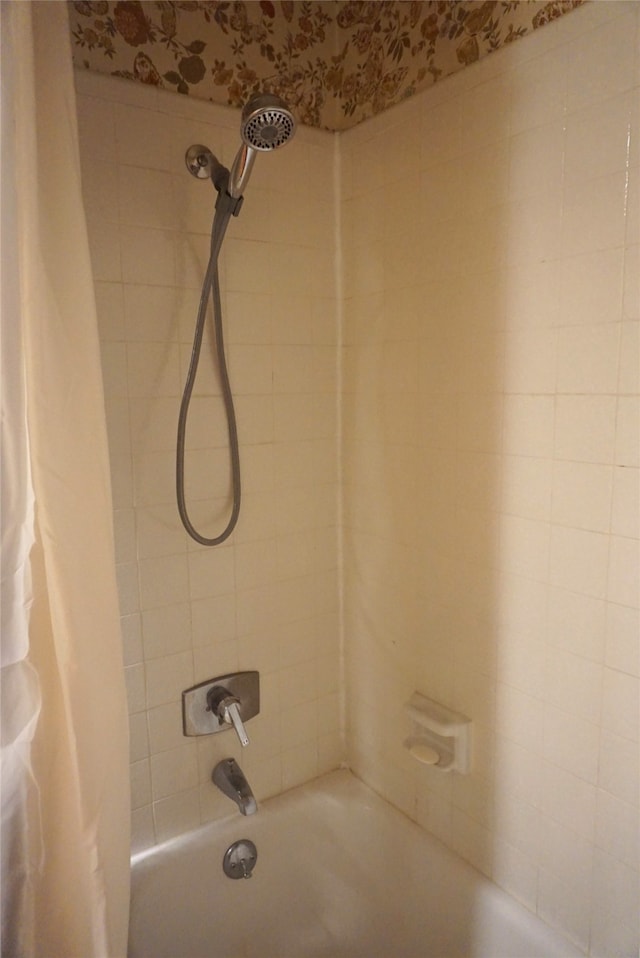 bathroom with shower / bath combo with shower curtain