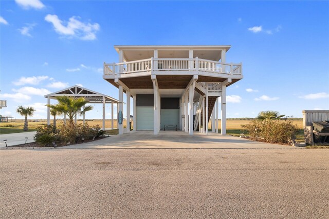 1286 Lagoon Dr, Crystal Beach, TX 77650 - beach home with driveway, stairs, a carport, and a deck