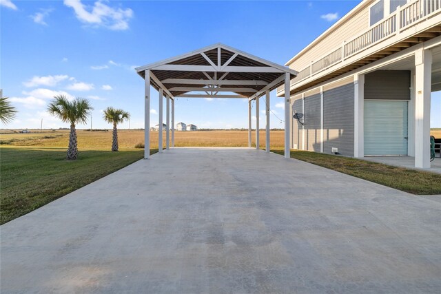 1286 Lagoon Dr, Crystal Beach, TX 77650 - view of patio with driveway, a detached carport, and a balcony