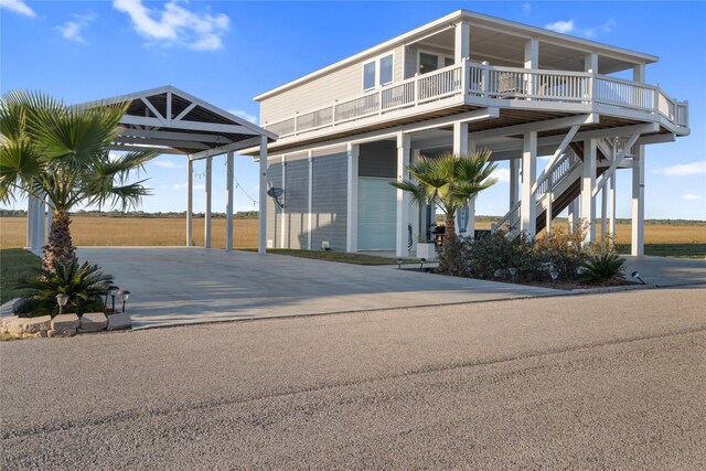 1286 Lagoon Dr, Crystal Beach, TX 77650 - view of front of home featuring concrete driveway and a carport