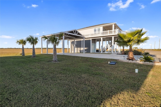 back of property with a yard and a patio area