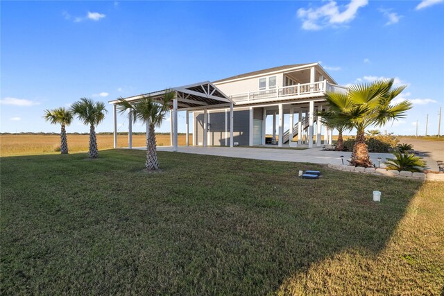 1286 Lagoon Dr, Crystal Beach, TX 77650 - rear view of house featuring stairway, a lawn, driveway, and a carport