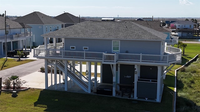 1286 Lagoon Dr, Crystal Beach, TX 77650 - rear view of property featuring roof with shingles, a residential view, and a yard